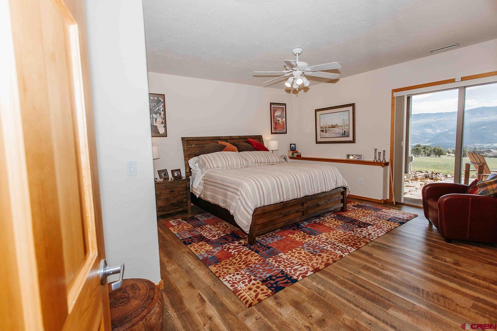 2118 Silverhorn Trail Ridgway, CO 81432 - Photo 24 of 35 a bedroom with a bed and wooden floor
