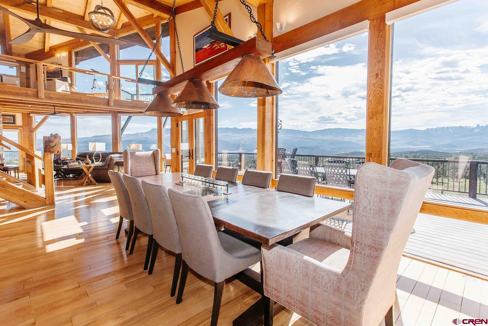 2118 Silverhorn Trail Ridgway, CO 81432 - Photo 3 of 35 a view of a dining room with furniture large windows and wooden floor