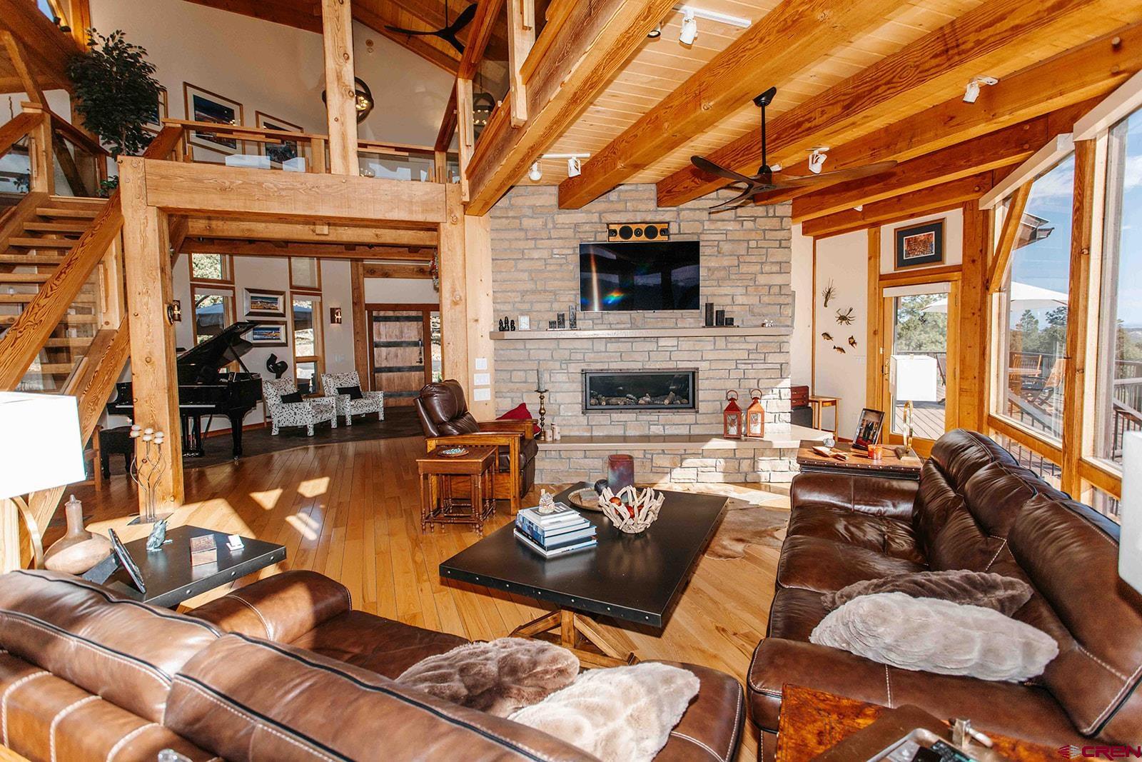 2118 Silverhorn Trail Ridgway, CO 81432 - Photo 10 of 35 a living room with furniture a flat screen tv and a fireplace