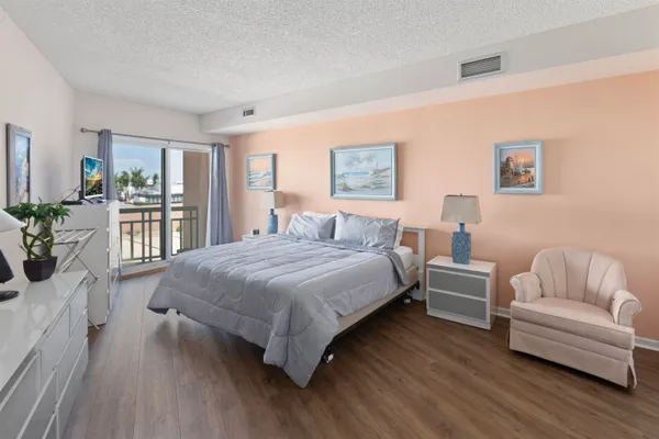 a spacious bedroom with a bed and a couch