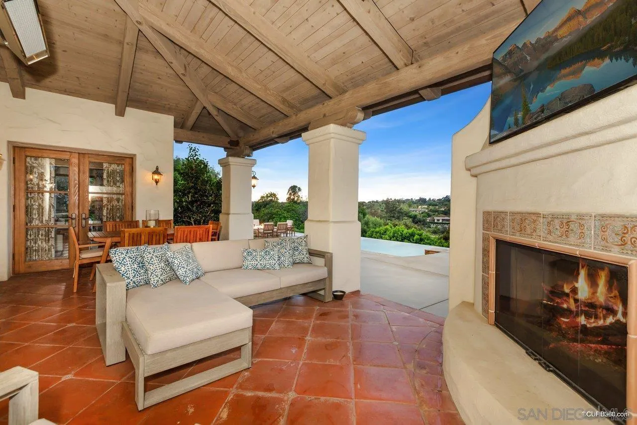 5530 Codorniz Rancho Santa Fe, CA 92067 - Photo 24 of 37 a view of a porch with furniture and a fireplace