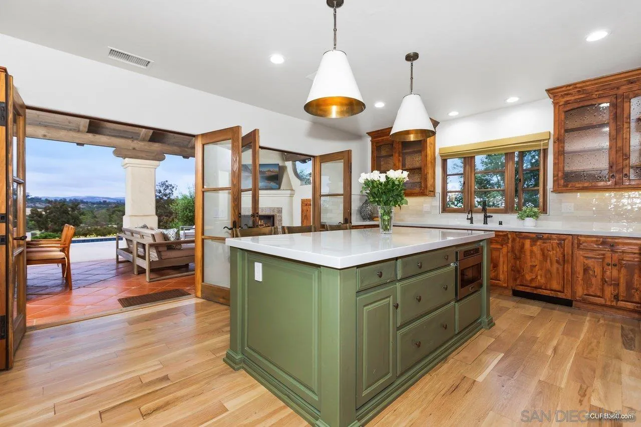 5530 Codorniz Rancho Santa Fe, CA 92067 - Photo 10 of 37 a kitchen with stainless steel appliances granite countertop a lot of counter space and wooden floors