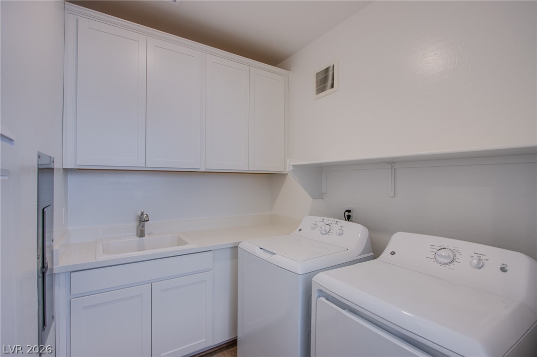 2555 Hampton Road, Unit 8201 Henderson, NV 89052 - Photo 15 of 33 A functional laundry space incorporates built-in cabinetry and a deep utility sink.