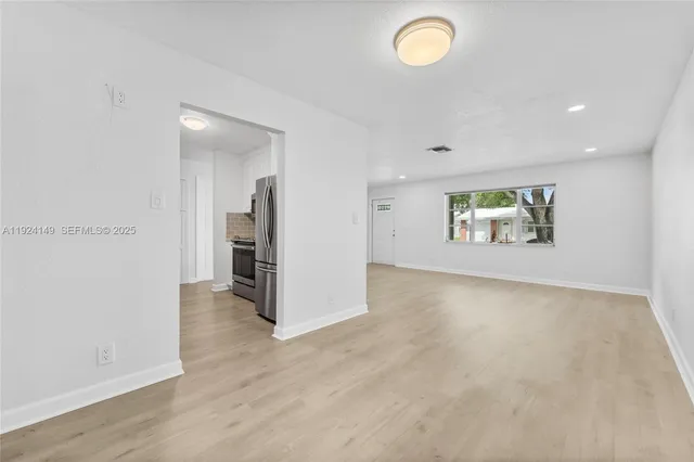 wooden floor in an empty room and a window
