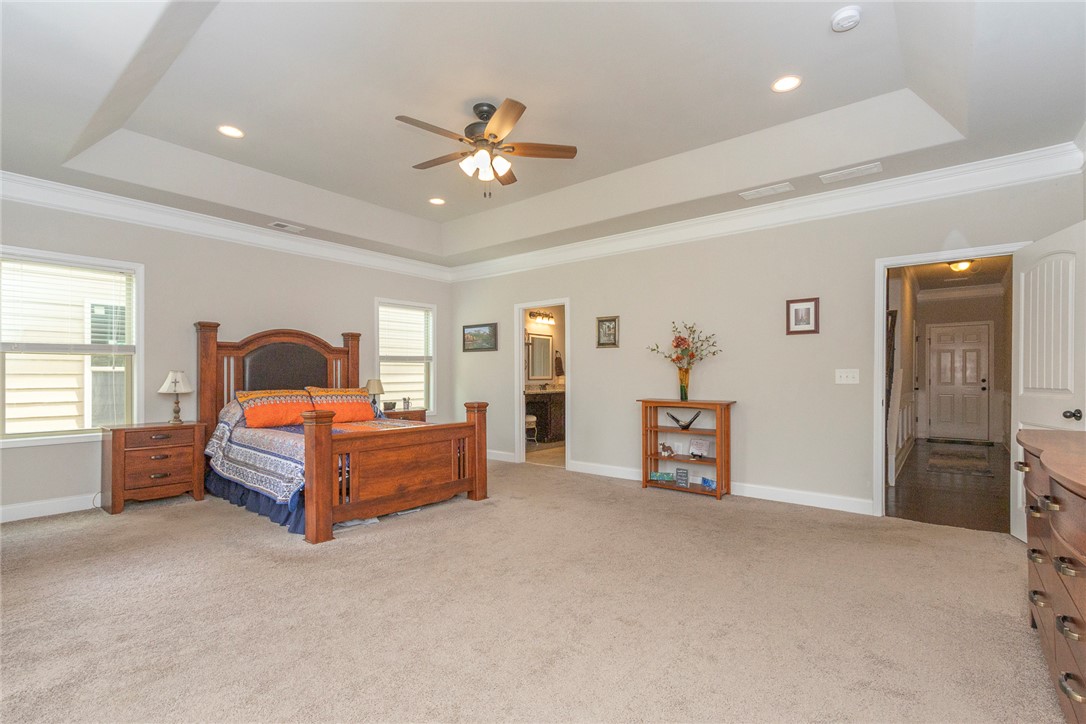 22 Old American Boulevard Pendleton, SC 29670 - Photo 13 of 49 This spacious bedroom features a tray ceiling, recessed lighting, and a ceiling fan for ultimate comfort.