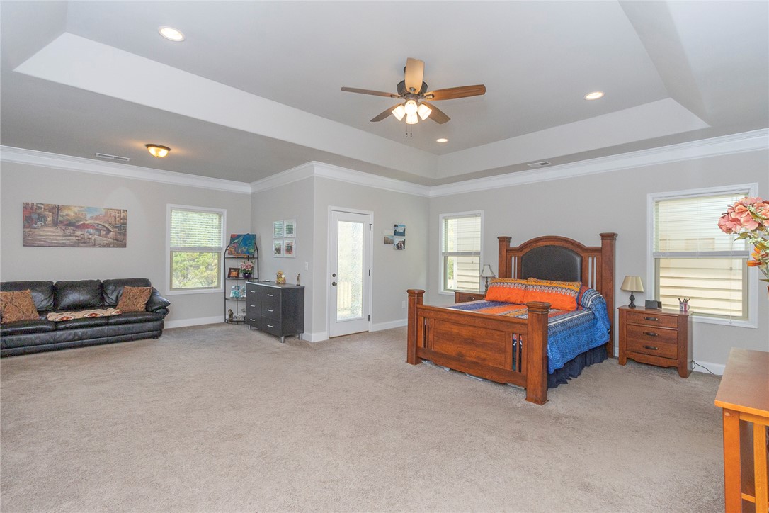 22 Old American Boulevard Pendleton, SC 29670 - Photo 14 of 49 This spacious bedroom features ample natural light and a charming outdoor access point.