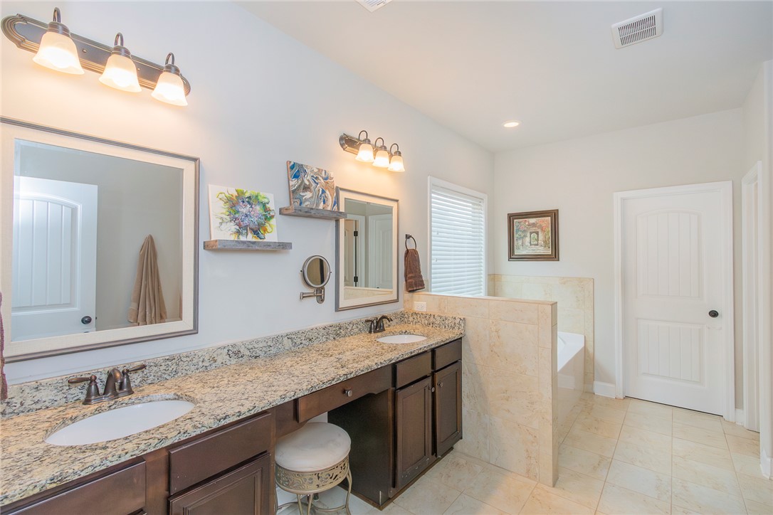 22 Old American Boulevard Pendleton, SC 29670 - Photo 16 of 49 This spacious bathroom offers dual vanities with ample counter space and a serene soaking tub.