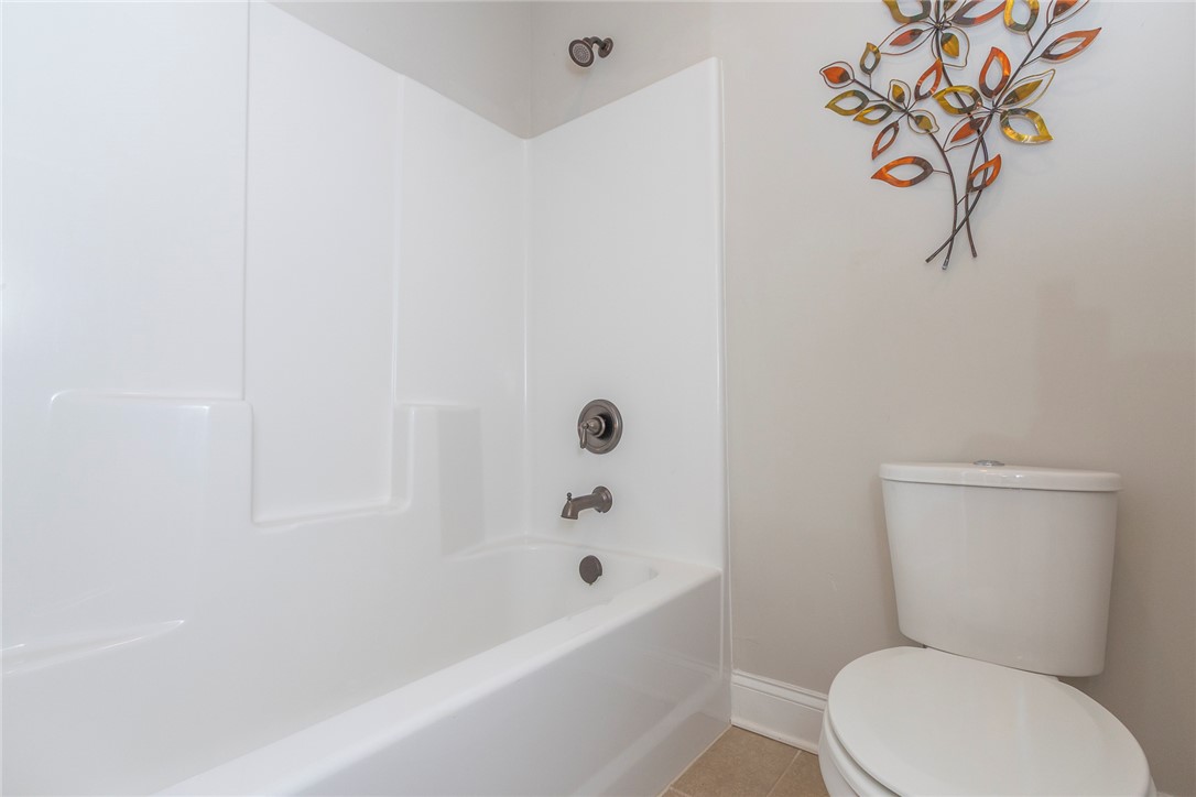 22 Old American Boulevard Pendleton, SC 29670 - Photo 20 of 49 This clean bathroom features a white tub and toilet, ready for daily routines.