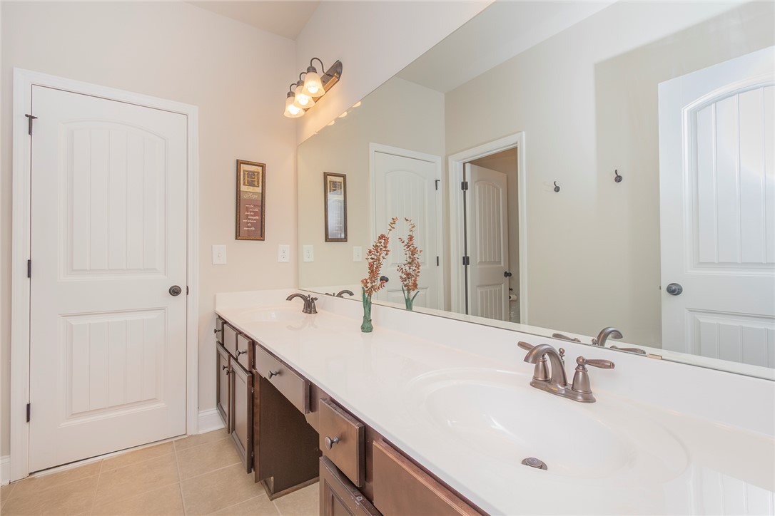 22 Old American Boulevard Pendleton, SC 29670 - Photo 21 of 49 This primary bathroom features a double vanity and tile flooring, offering practical elegance.
