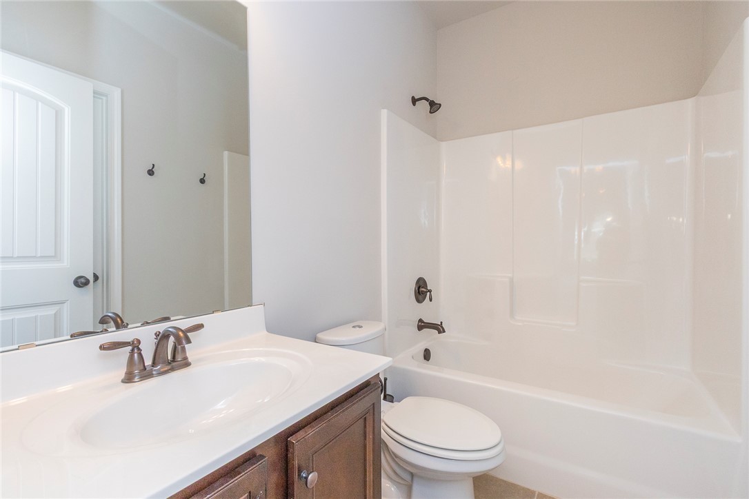 22 Old American Boulevard Pendleton, SC 29670 - Photo 24 of 49 This clean and functional bathroom features a single vanity, modern fixtures, and a shower-tub combination.
