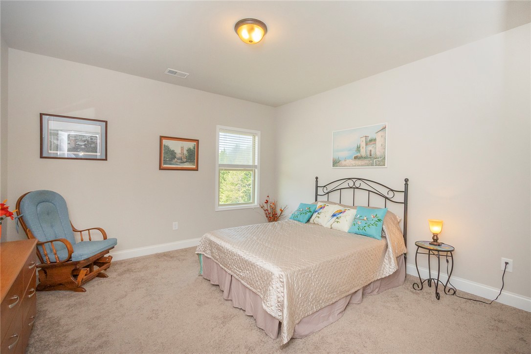 22 Old American Boulevard Pendleton, SC 29670 - Photo 25 of 49 This spacious bedroom offers ample natural light and plush carpeting, creating a comfortable living space.