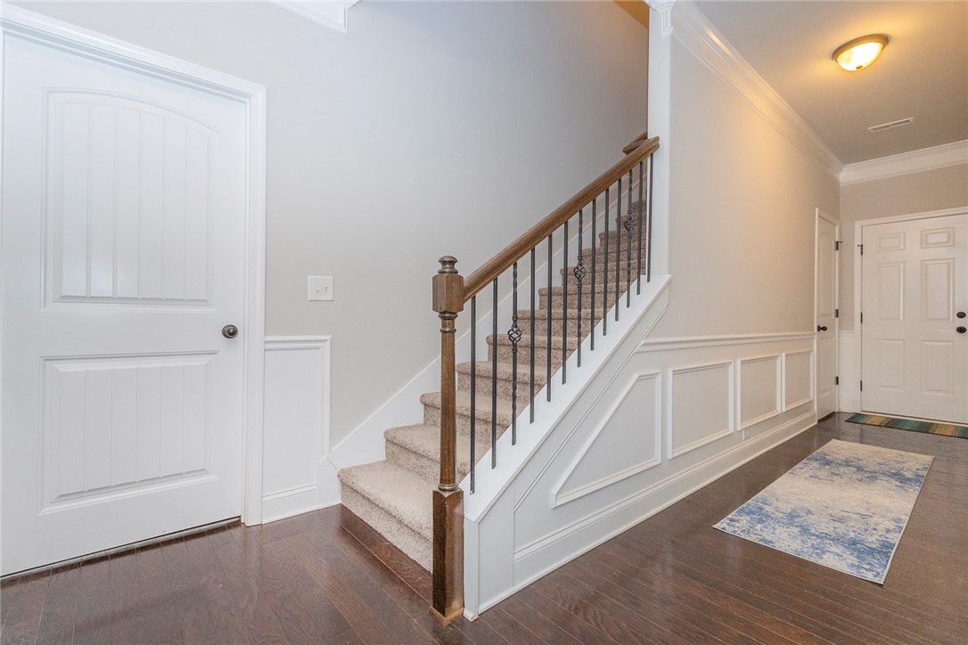 22 Old American Boulevard Pendleton, SC 29670 - Photo 26 of 49 This inviting foyer features hardwood flooring and a carpeted staircase with an elegant railing.