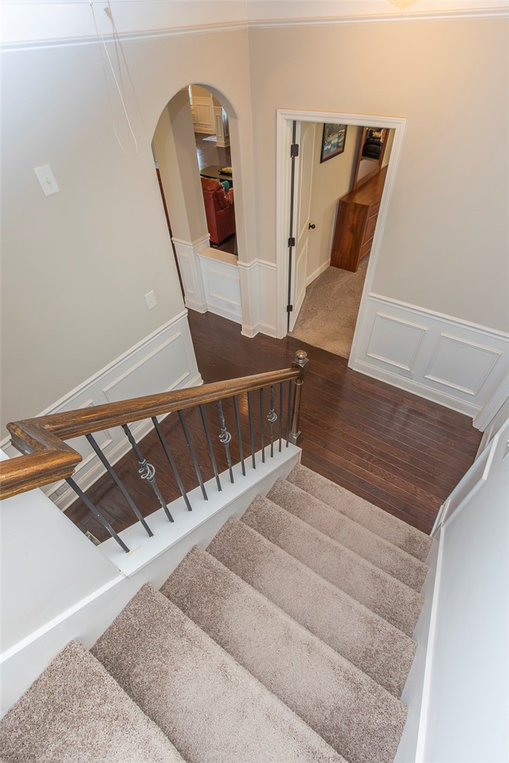 22 Old American Boulevard Pendleton, SC 29670 - Photo 30 of 49 This inviting interior features elegant wainscoting and warm hardwood floors, leading to a cozy living space.
