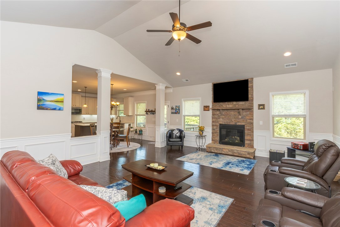 22 Old American Boulevard Pendleton, SC 29670 - Photo 3 of 49 This inviting living room seamlessly connects to the kitchen, featuring high ceilings and a cozy fireplace.