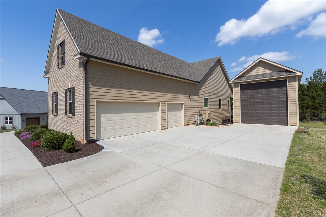 22 Old American Boulevard Pendleton, SC 29670 - Photo 49 of 49 This spacious garage and detached outbuilding provide ample parking and storage options.