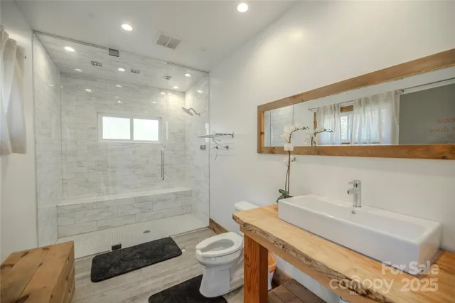 a view of a hallway with wooden floor and a window