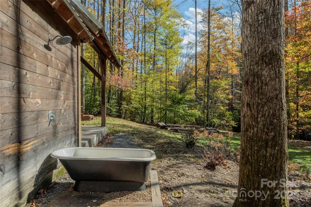 a view of backyard with swimming pool and sitting area