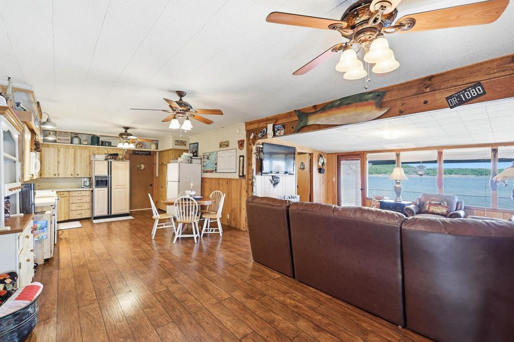 4513 Chapel Road Graham, TX 76450 - Photo 7 of 38 a living room with couches a dining table and chairs with wooden floor