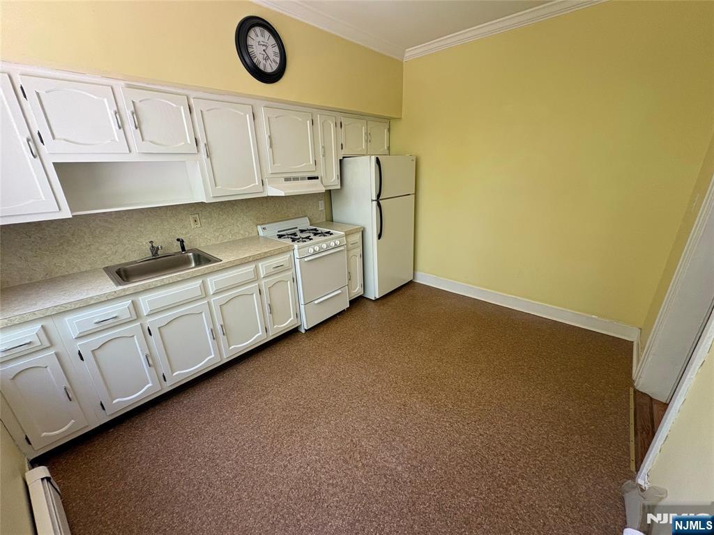 38 River Edge Road, Unit 40B River Edge, NJ 07661 - Photo 5 of 11 a kitchen with granite countertop white cabinets and a sink