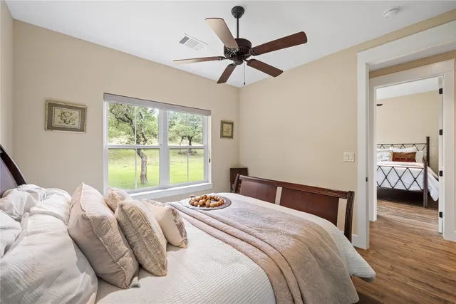 a bedroom with a bed and a large window