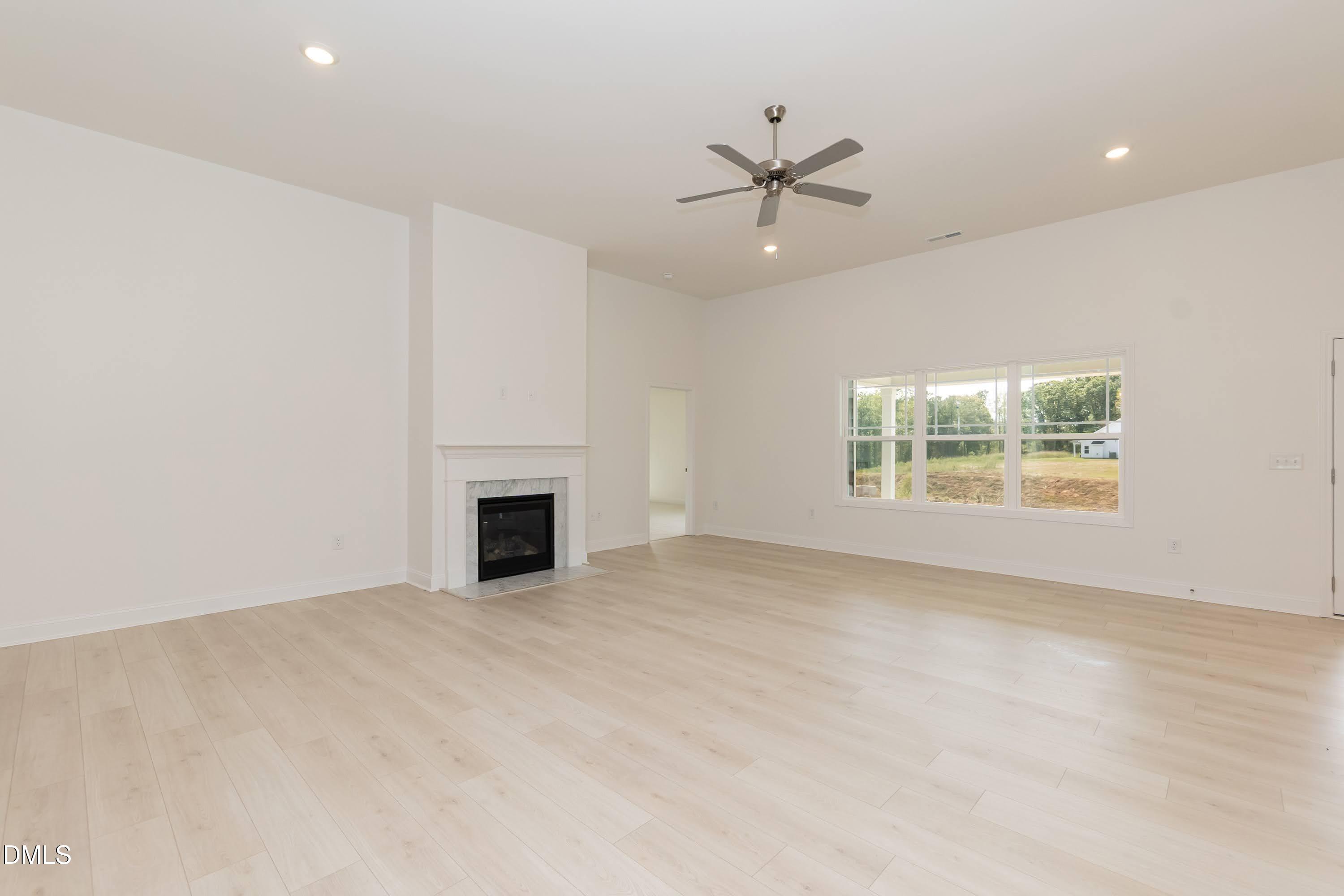 254 Galway Road Lillington, NC 27546 - Photo 7 of 35 an empty room with windows and fireplace