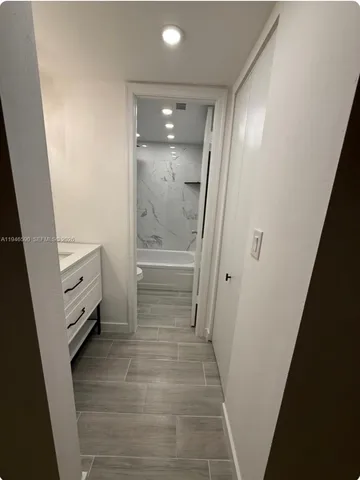 a view of a room with wooden floor and a window