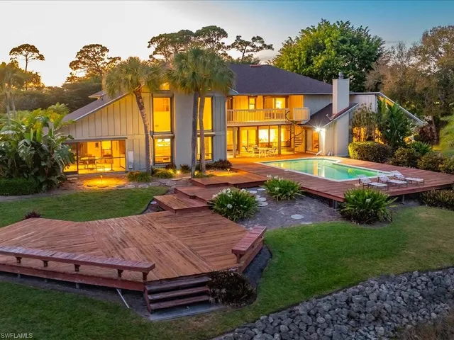 a view of a house with backyard and a patio