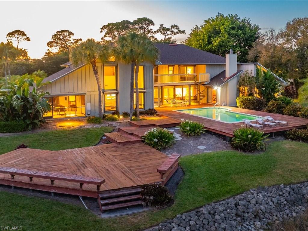 154 Cajeput Drive Naples, FL 34108 - Photo 1 of 45 a view of a house with backyard and a patio