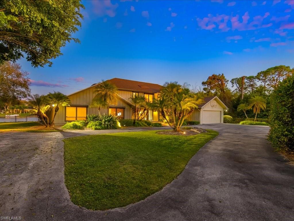 154 Cajeput Drive Naples, FL 34108 - Photo 14 of 45 a view of a large trees with a big yard