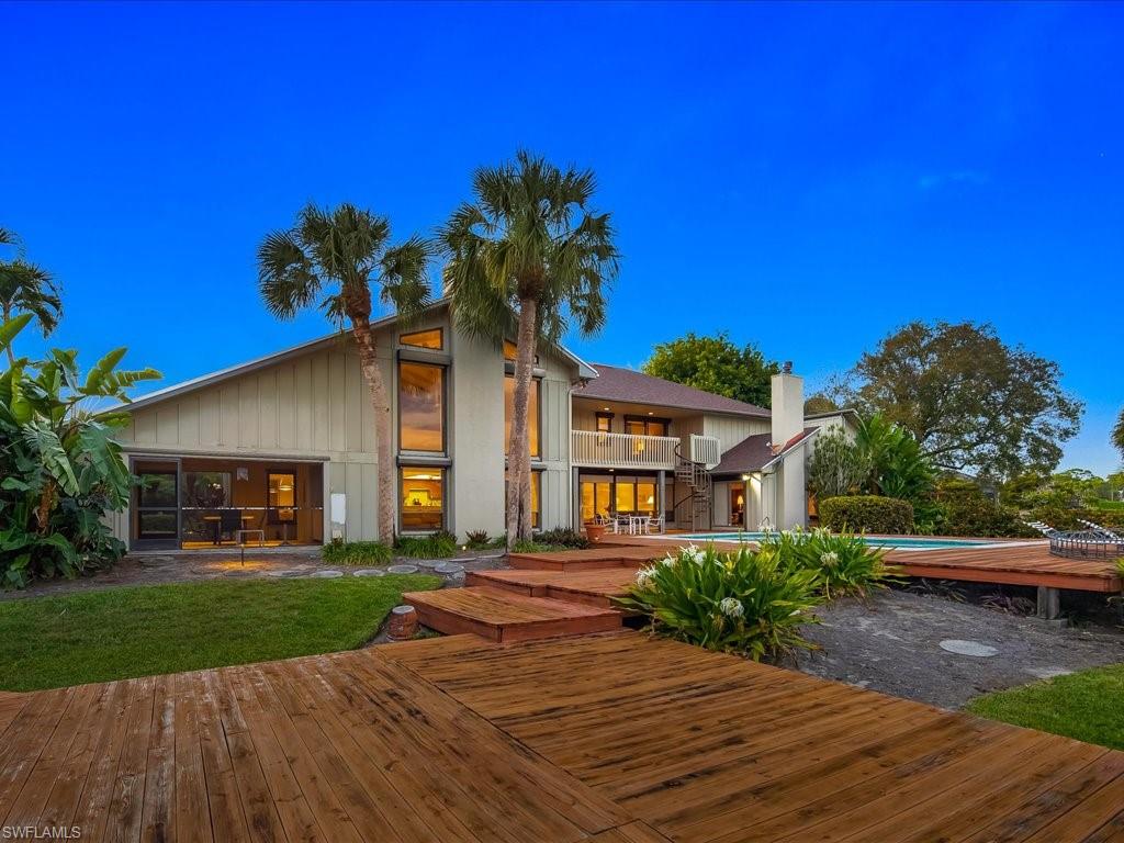 154 Cajeput Drive Naples, FL 34108 - Photo 15 of 45 a front view of a house with a yard