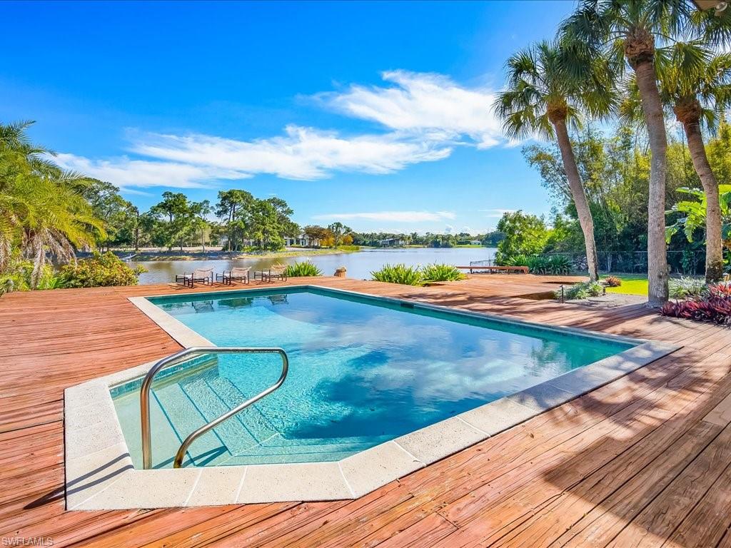 154 Cajeput Drive Naples, FL 34108 - Photo 20 of 45 a view of a swimming pool with a yard