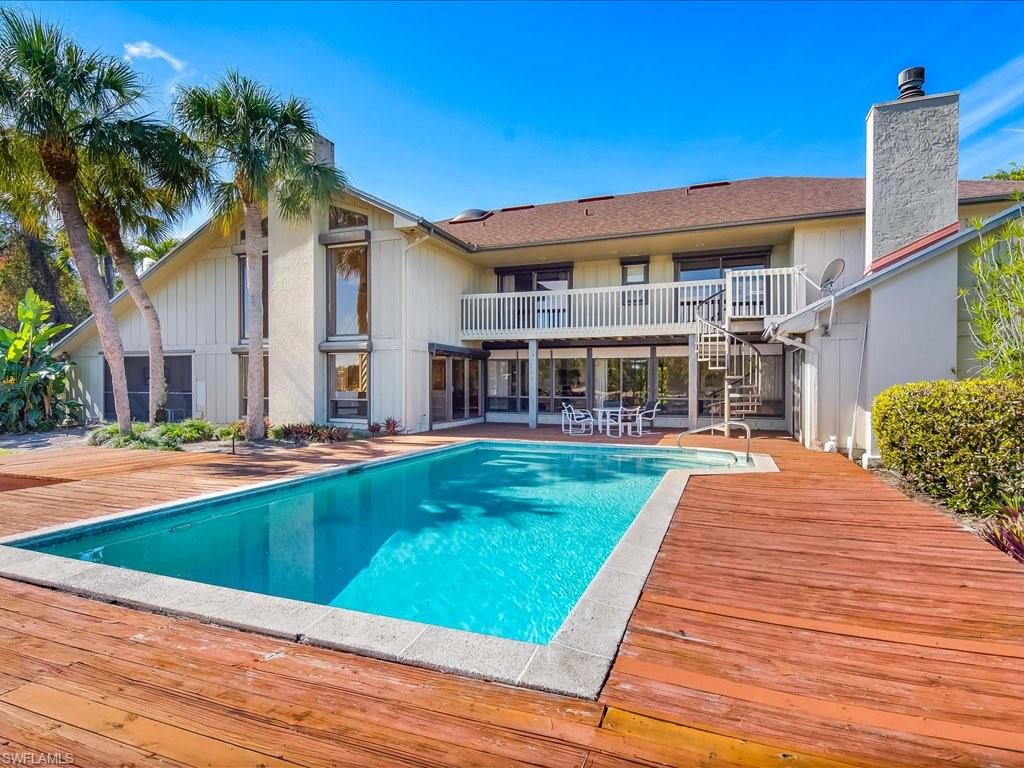 154 Cajeput Drive Naples, FL 34108 - Photo 22 of 45 a view of house with yard and swimming pool
