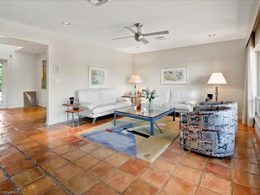 154 Cajeput Drive Naples, FL 34108 - Photo 24 of 45 a living room with furniture and a table