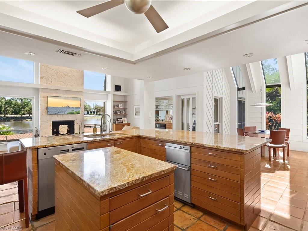 154 Cajeput Drive Naples, FL 34108 - Photo 28 of 45 a kitchen with granite countertop a stove and cabinets