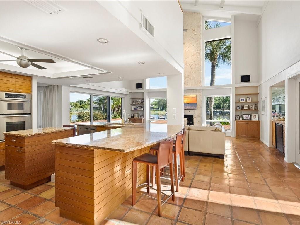 154 Cajeput Drive Naples, FL 34108 - Photo 29 of 45 a view of a living room and kitchen