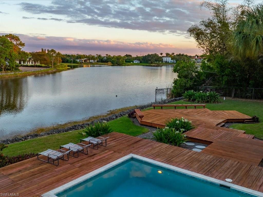 154 Cajeput Drive Naples, FL 34108 - Photo 3 of 45 a view of a lake with a city view