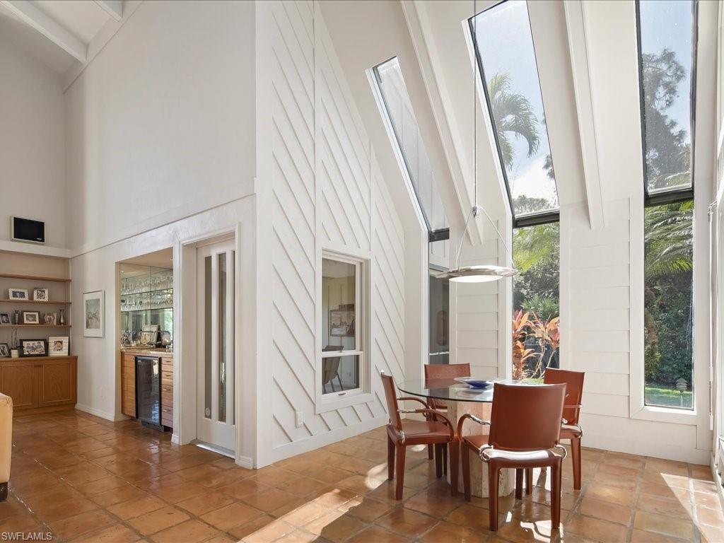 154 Cajeput Drive Naples, FL 34108 - Photo 33 of 45 a view of a dining room with furniture window and wooden floor