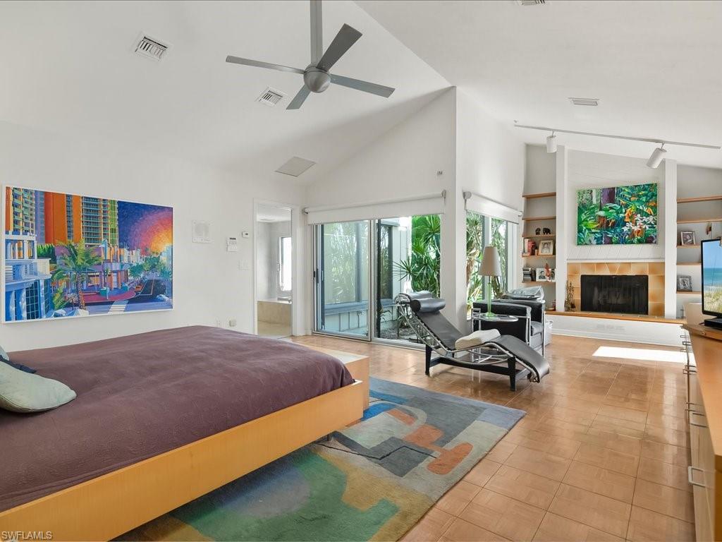 154 Cajeput Drive Naples, FL 34108 - Photo 35 of 45 a living room with furniture fireplace and a flat screen tv