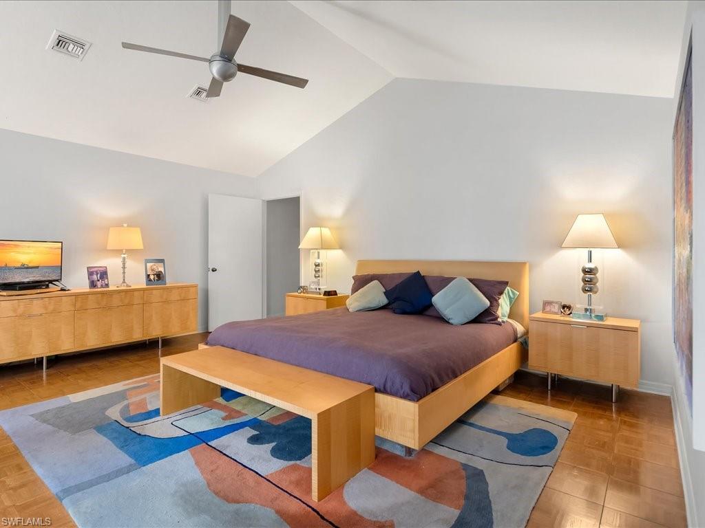 154 Cajeput Drive Naples, FL 34108 - Photo 36 of 45 a bed room with a bed and a night stand