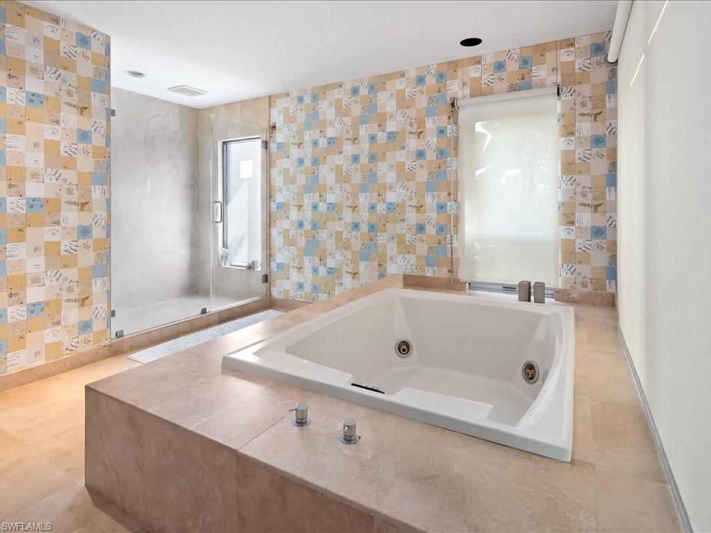 154 Cajeput Drive Naples, FL 34108 - Photo 38 of 45 a bath tub sitting in a bathroom next to a window