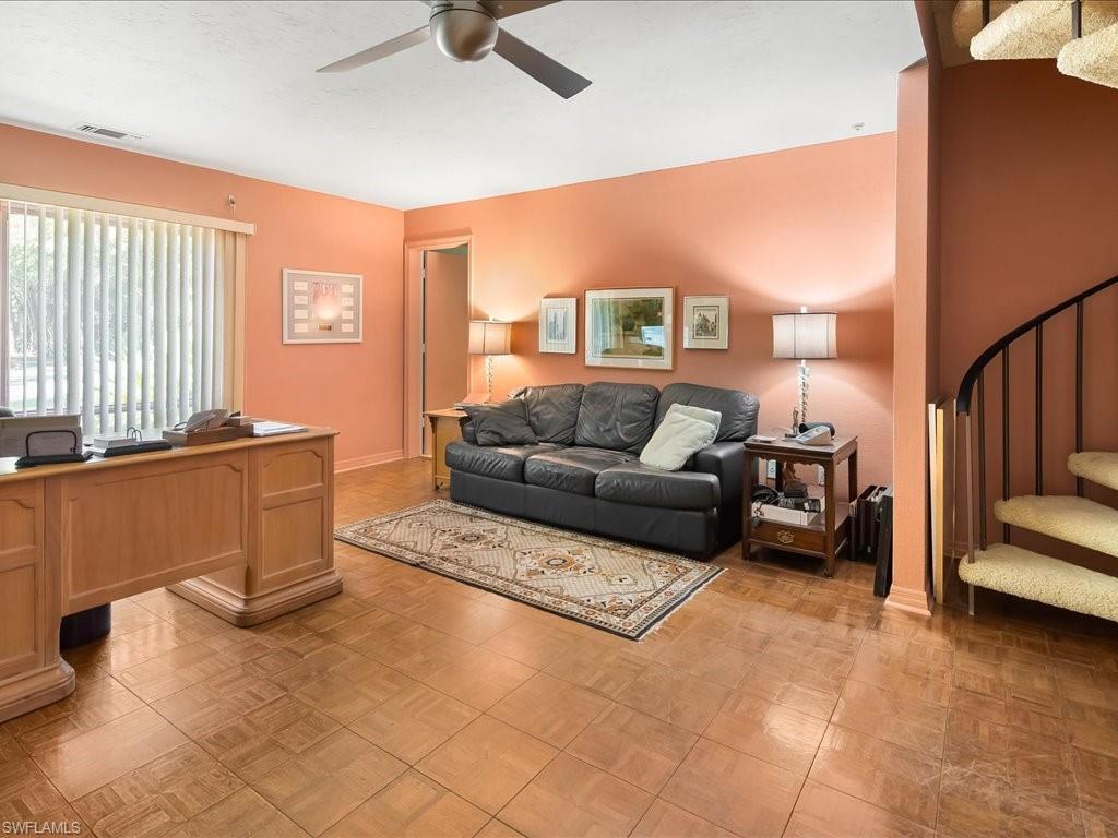 154 Cajeput Drive Naples, FL 34108 - Photo 39 of 45 a living room with furniture and a flat screen tv