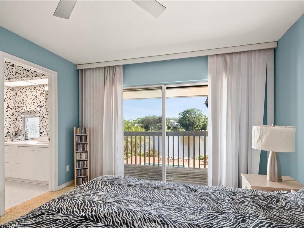 154 Cajeput Drive Naples, FL 34108 - Photo 41 of 45 a bedroom with a bed and a window