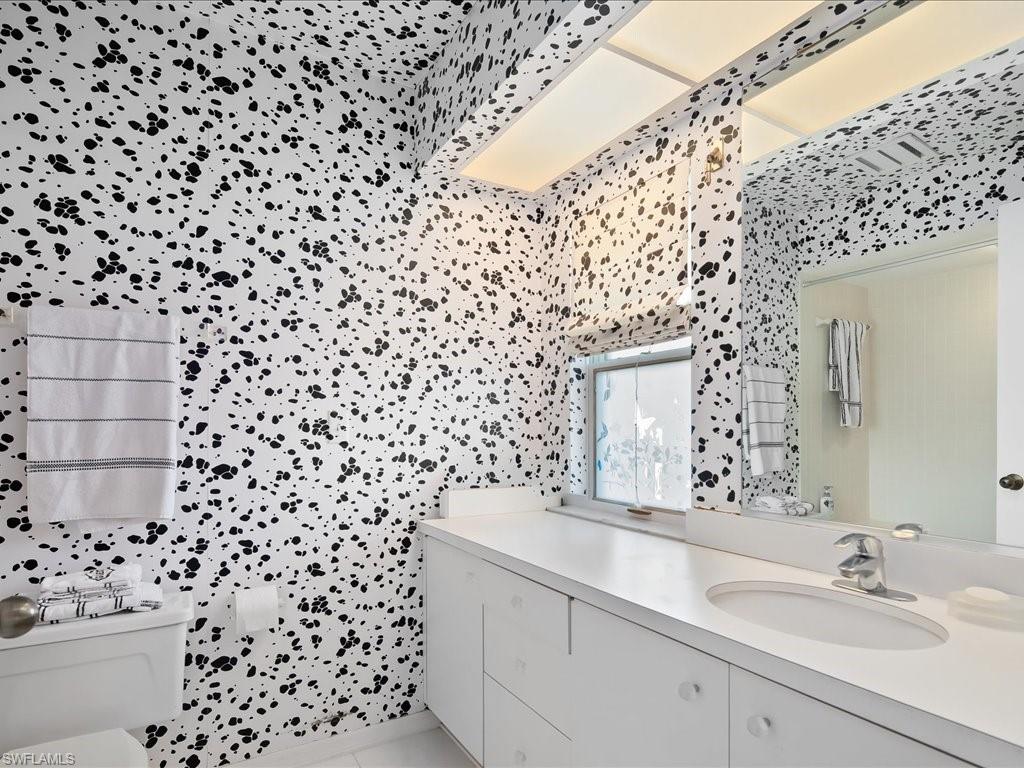 154 Cajeput Drive Naples, FL 34108 - Photo 42 of 45 a bathroom with a sink a toilet and a shower