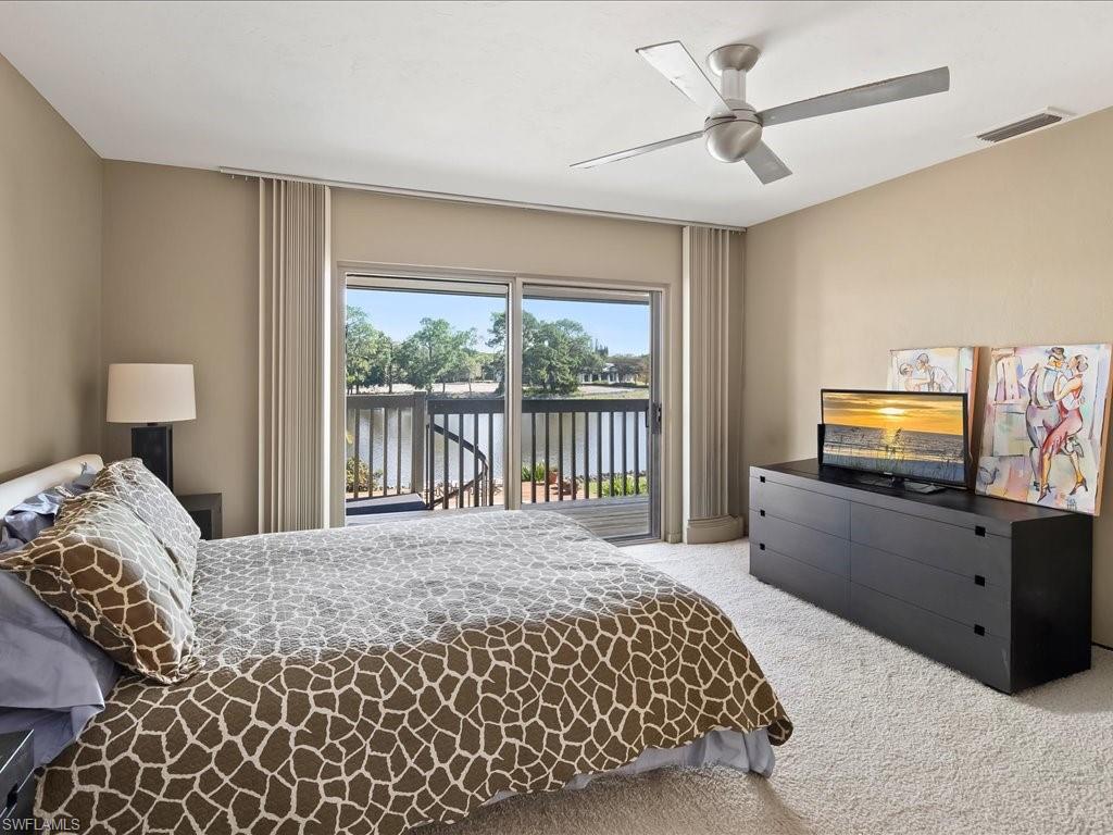 154 Cajeput Drive Naples, FL 34108 - Photo 43 of 45 a bedroom with a bed and tv on dresser