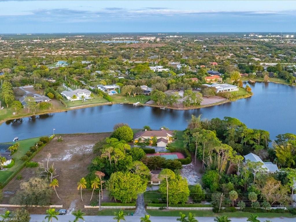 154 Cajeput Drive Naples, FL 34108 - Photo 9 of 45 an aerial view of residential building and lake