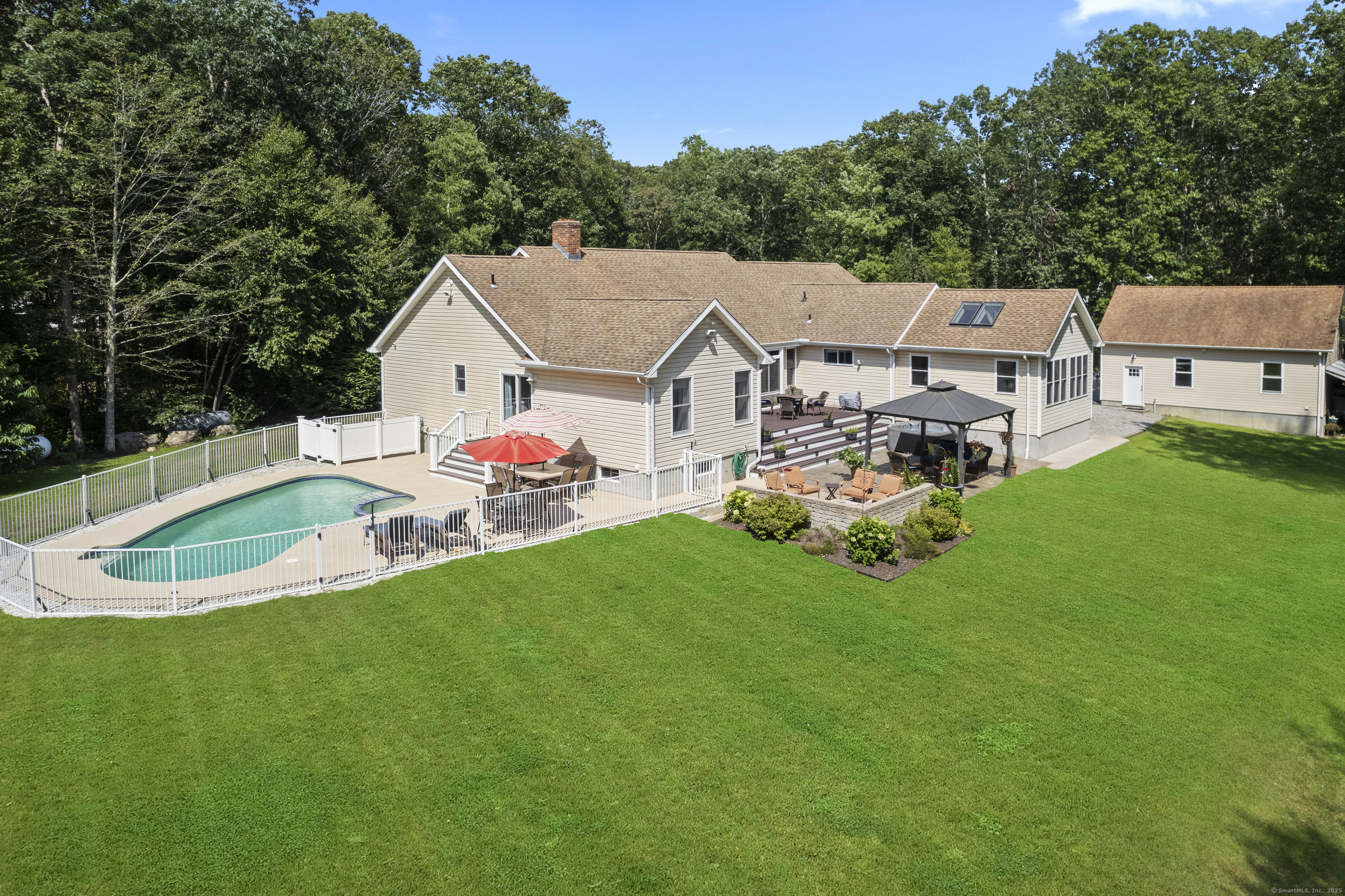 a aerial view of a house with a yard table and chairs