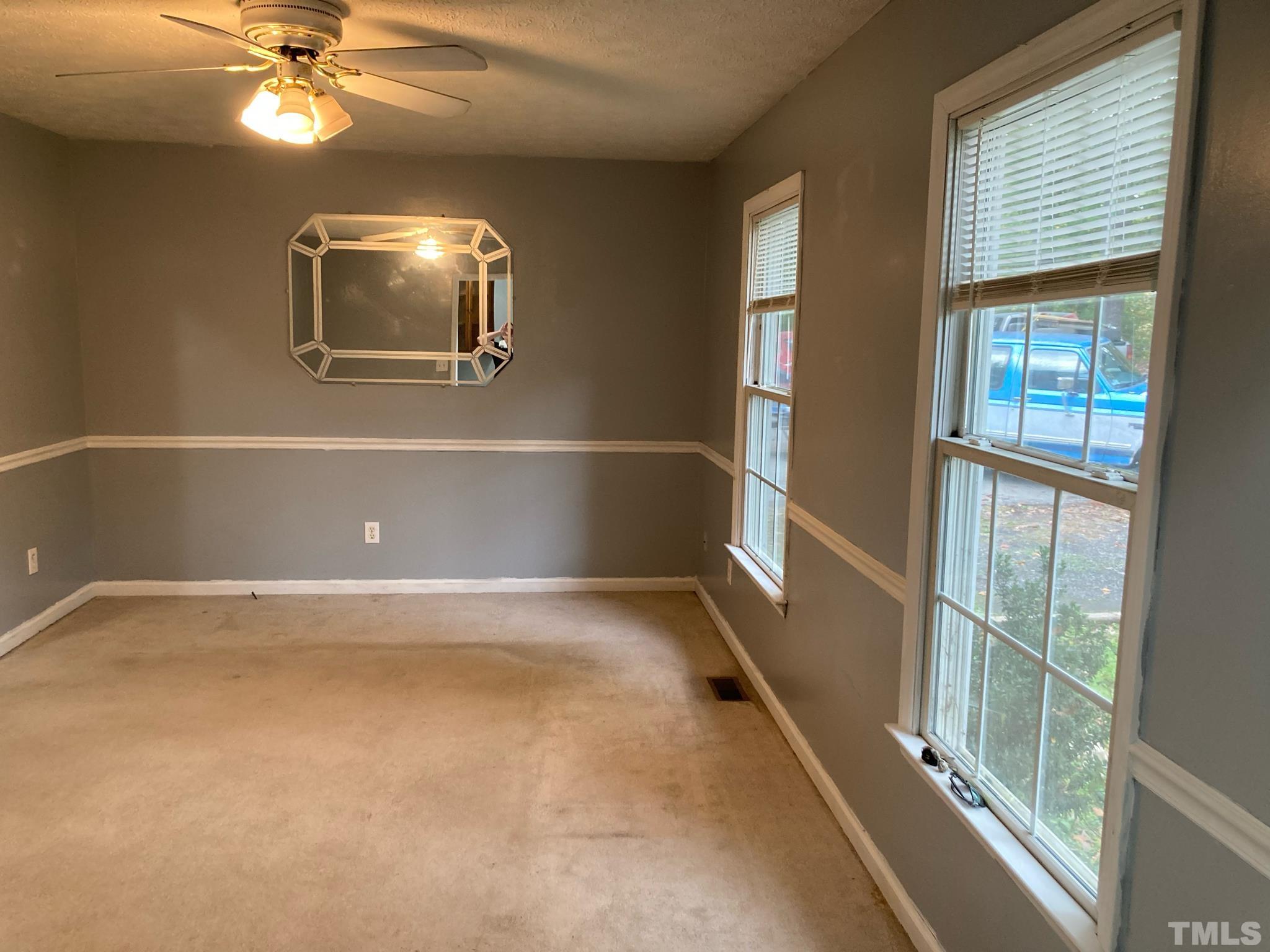 5924 Virgilina Road Roxboro, NC 27574 - Photo 2 of 6 en empty room with windows and ceiling fan