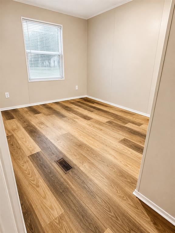9455 Tranquil Acres Road Fort Worth, TX 76179 - Photo 12 of 20 Room featuring wood-finish flooring, neutral wall tones, a white window with blinds, and white baseboards