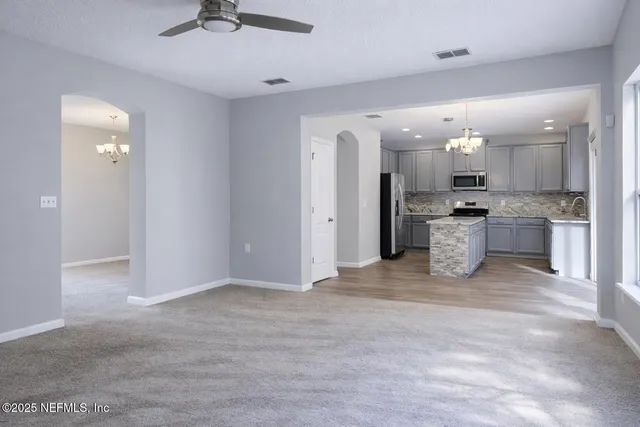 a view of kitchen with refrigerator stove and microwave