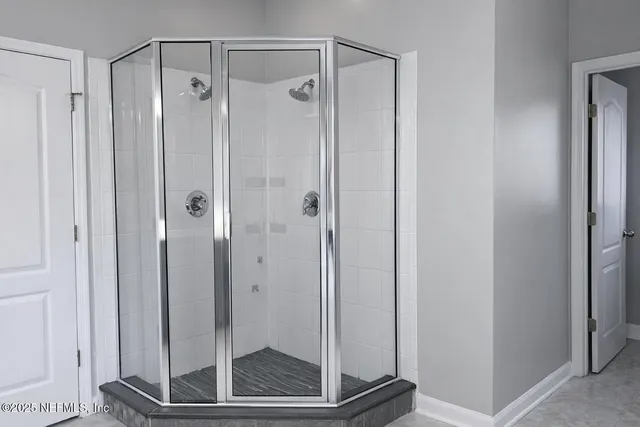 a bathroom with a shower and a sink